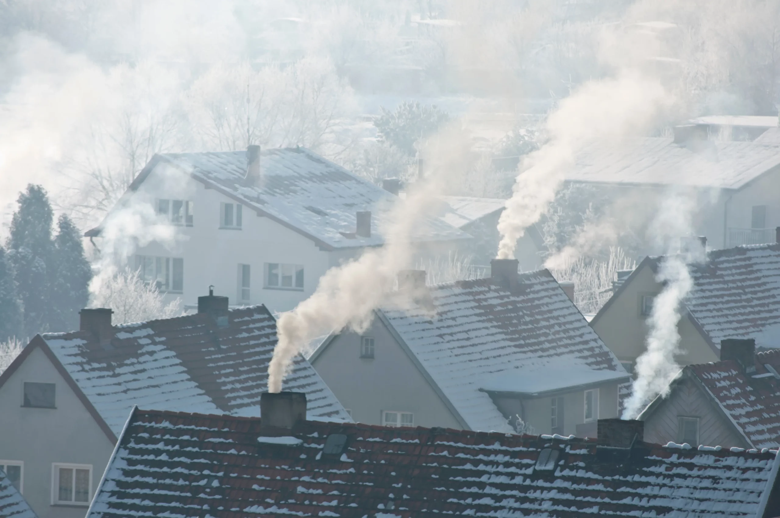 A community of homes with smoking chimney during the winter months