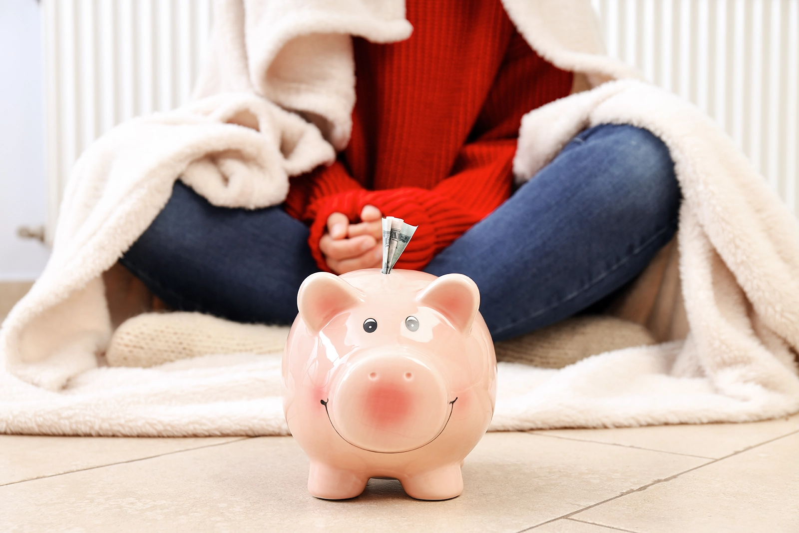 piggy bank saving money for girl wrapped in blanket