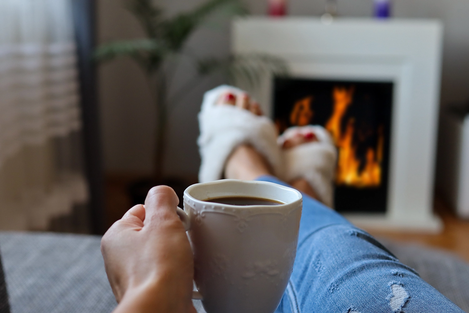 drinking hot tea by fireplace. warm and comfy